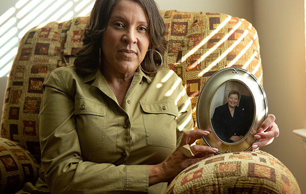 Francesca Johnson holds a portrait of her mother, Gwynne McCathorine